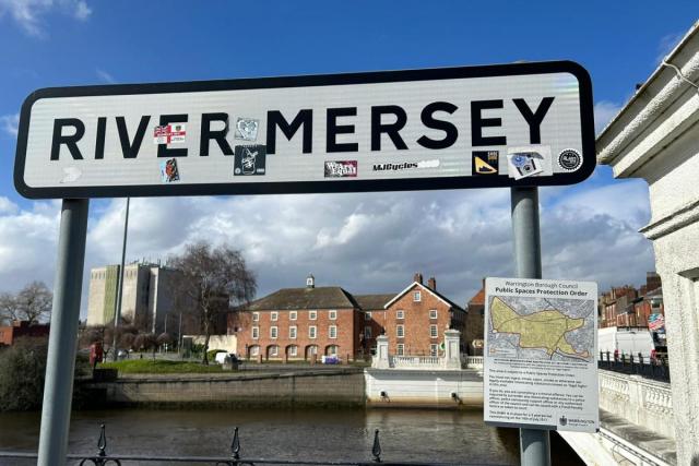 A polluted river with plastic waste and debris floating on the surface, illustrating the problem in the River Mersey.