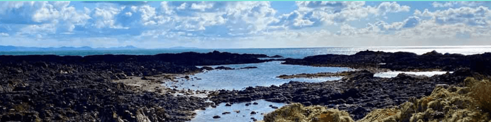 A scientist working in a modern laboratory at Liverpool John Moores University, surrounded by scientific equipment.